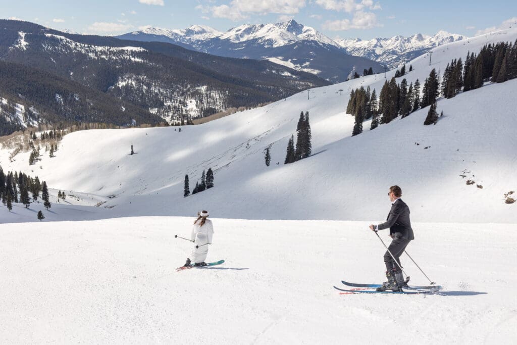 Wedding couple skiing at vail